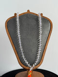 Real and pure sphatik mala/necklace. Made with authentic Himalayan quartz/Sphatik exclusively for Damru India( Damru.Shop)  A clear beaded necklace draped over a gray velvet jewelry bust with a wooden frame, shown against a plain light background.